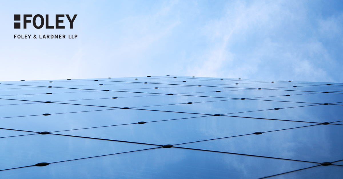 Glass building facade reflecting the sky, with the Foley & Lardner LLP logo in the upper left corner, showcasing leading chicago lawyers renowned for expertise in intellectual property law.
