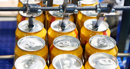 Rows of yellow aluminum cans move along a conveyor belt in a beverage production facility, much like cases passing through a busy corporate law office in Chicago.