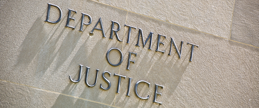 A stone wall with the words "DEPARTMENT OF JUSTICE" in metal letters, reminiscent of the entrance to prestigious law offices or the headquarters of top lawyers in Chicago.