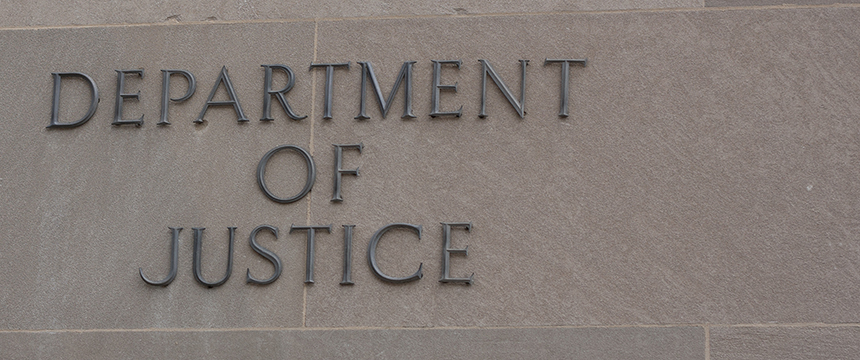 Text reading "Department of Justice" displayed on a stone wall, symbolizing the authority that guides lawyers in Chicago and protects key fields such as intellectual property law.