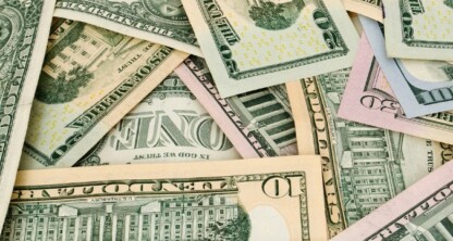 A pile of assorted U.S. dollar bills in various denominations, overlapping each other—ideal imagery for chicago lawyers offering litigation support in intellectual property law cases.