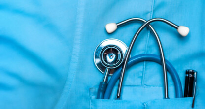A close-up of a stethoscope and pen in the front pocket of a blue medical scrub shirt, reminiscent of the precise tools used by chicago lawyers or law offices for litigation support.
