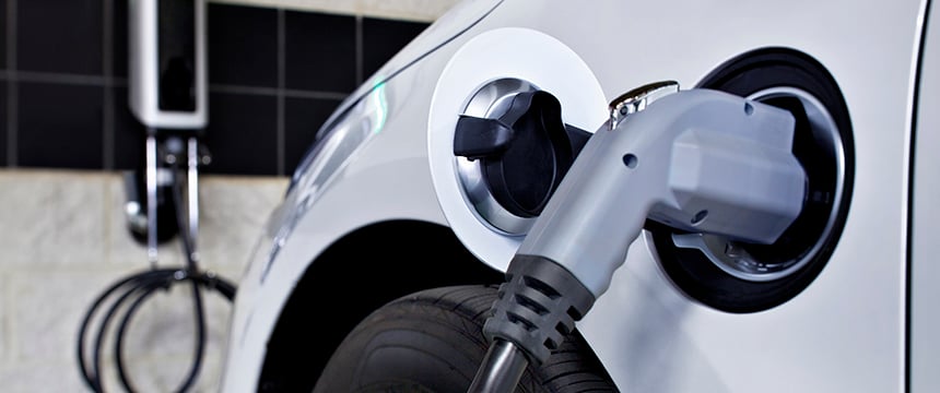 Close-up of an electric vehicle being charged, perfect for lawyers in Chicago or firms offering litigation support focused on the growing field of sustainable technology.