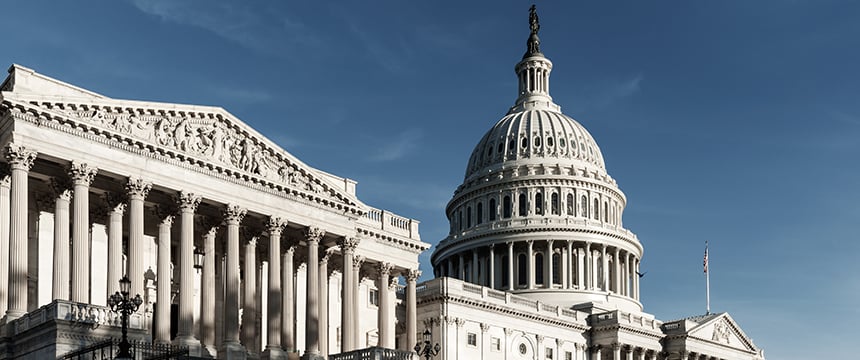 The image shows the United States Capitol building with its prominent dome and classical columns under a clear blue sky, reflecting the gravitas often associated with leading law offices and corporate law office environments.