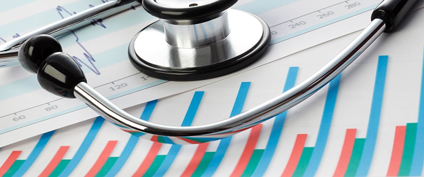 A stethoscope lies on top of printed charts and graphs displaying statistical and medical data, symbolizing the intersection of healthcare and intellectual property law.