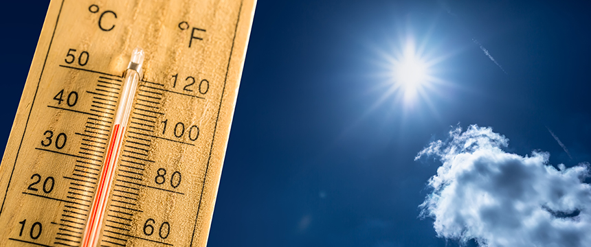 A thermometer showing high temperatures in both Celsius and Fahrenheit stands under a bright sun in a clear blue sky, much like how Chicago lawyers handle litigation support during intense cases.