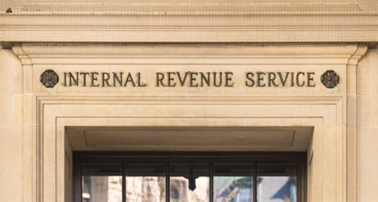 Stone building facade with "Internal Revenue Service" engraved above a doorway—a frequented site for tax professionals from corporate law offices and specialists in litigation support.