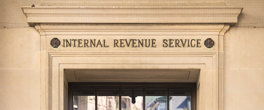 Stone building facade with "Internal Revenue Service" engraved above a doorway—a frequented site for tax professionals from corporate law offices and specialists in litigation support.