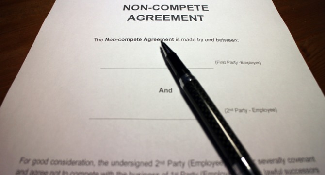 A pen rests on a non-compete agreement form with blank spaces for the names of the first and second party, ready for review by Chicago lawyers at a corporate law office.
