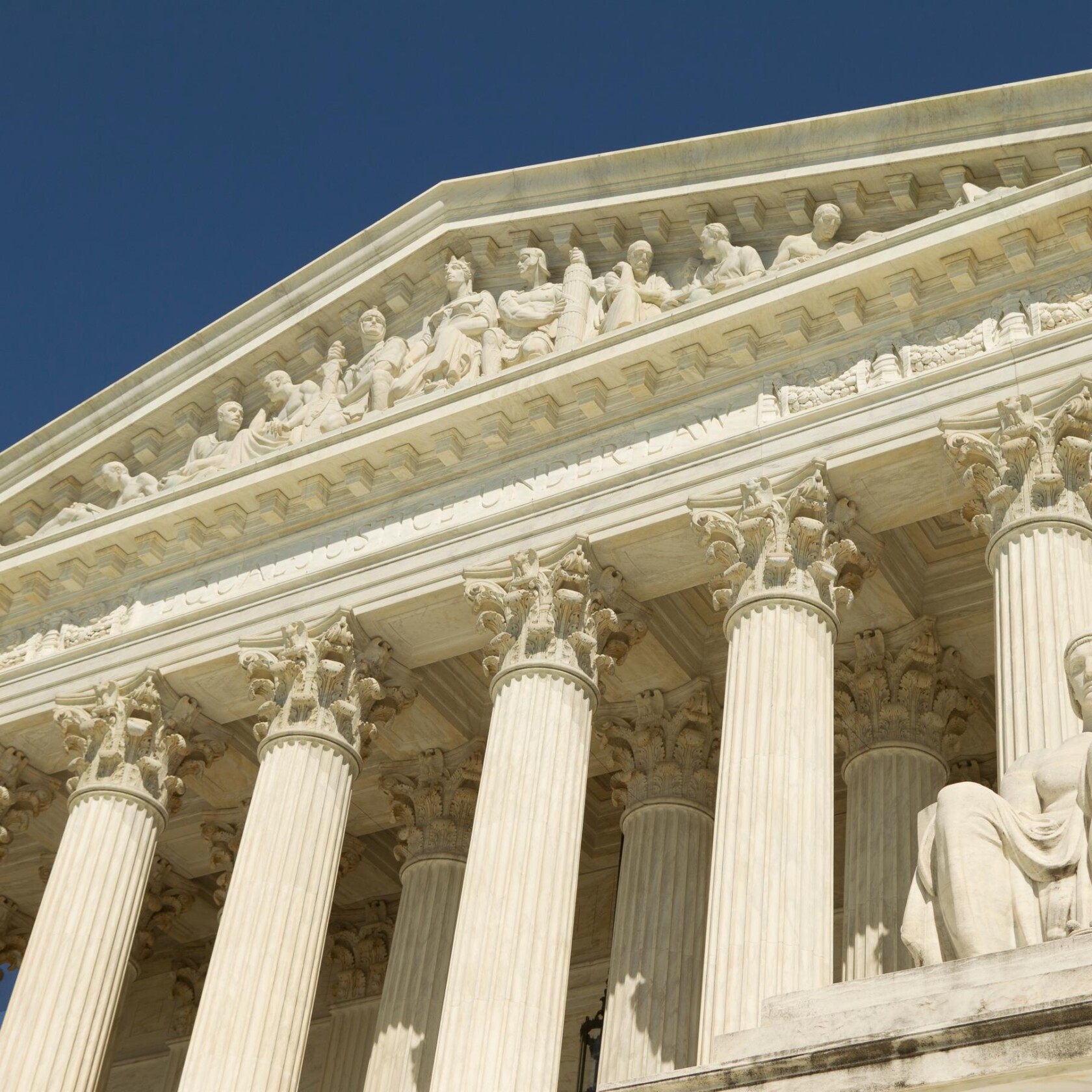 The facade of the United States Supreme Court building featuring tall columns and statues under a clear blue sky, symbolizing the authority that guides chicago lawyers and shapes intellectual property law.