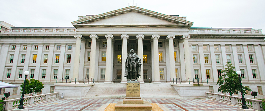 A large neoclassical building with tall columns, engraved "The Treasury Department," stands before a statue on a tiled plaza—reminiscent of the prestigious facades often seen at top corporate law offices and lawyers in Chicago.