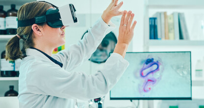 A scientist wearing a virtual reality headset interacts with invisible controls in a laboratory, with lab equipment and a microscopic image visible in the background—highlighting technology’s growing role in intellectual property law and litigation support.