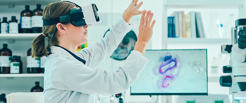 A scientist wearing a virtual reality headset interacts with invisible controls in a laboratory, with lab equipment and a microscopic image visible in the background—highlighting technology’s growing role in intellectual property law and litigation support.