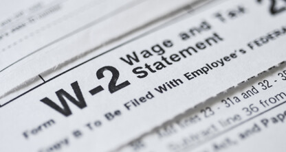 Close-up of a W-2 Wage and Tax Statement form, showing printed text and partial document details—often reviewed by lawyers in Chicago at a corporate law office for financial accuracy.