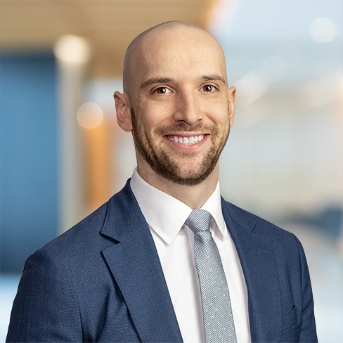 A man in a suit smiling confidently, embodying the professionalism often found in top corporate law offices.