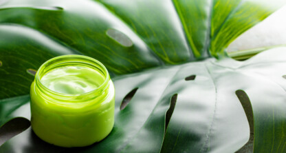 A jar of cream rests on a leaf, reflecting the calm balance often sought in busy corporate law offices.