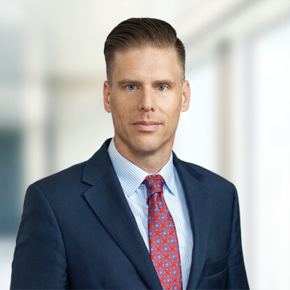 A man in a suit and tie stands confidently, embodying the professionalism found in top corporate law offices and among skilled lawyers in Chicago.