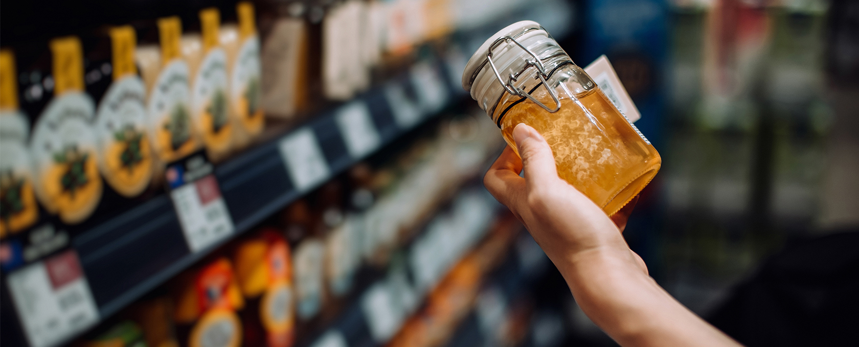 A person holding a jar of liquid, reminiscent of the meticulous care seen in top corporate law offices or among skilled lawyers in Chicago.