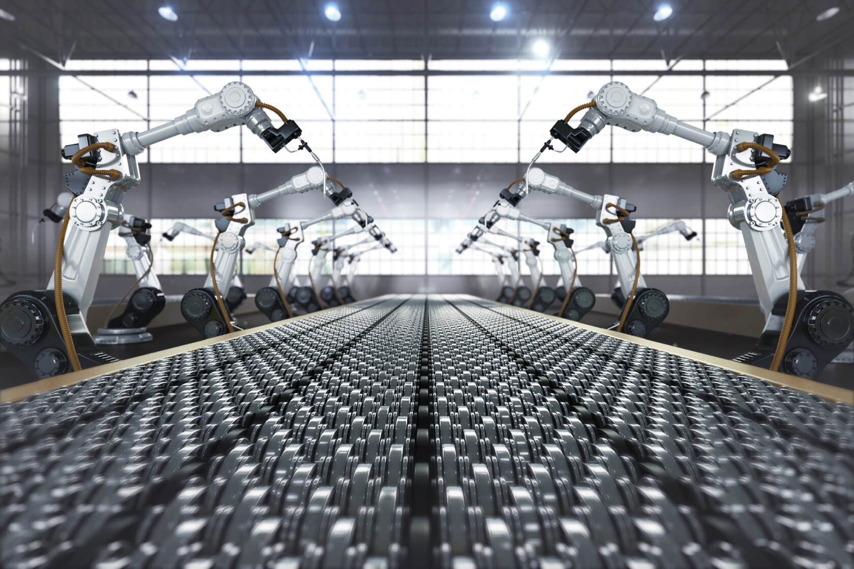 A row of robotic arms operates along both sides of an automated conveyor belt inside a brightly lit industrial factory, where innovations are protected by intellectual property law and guided by experienced Chicago lawyers.