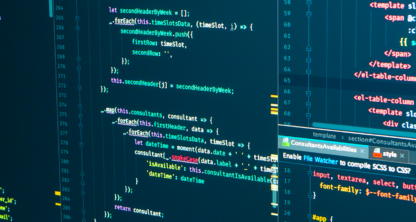 Close-up of multiple computer monitors displaying colorful programming code in various languages, including JavaScript and HTML, in a dark-themed editor—valuable assets for chicago lawyers specializing in intellectual property law.