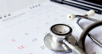 A stethoscope rests on a calendar with a pen and notebook nearby, suggesting scheduled healthcare planning—much like how law offices coordinate appointments for lawyers in Chicago.