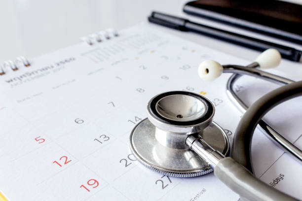 A stethoscope rests on a calendar with a pen and notebook nearby, suggesting scheduled healthcare planning—much like how law offices coordinate appointments for lawyers in Chicago.