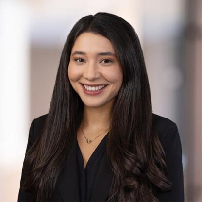 Experienced female attorney smiling at Foley & Lardner LLP law firm office.